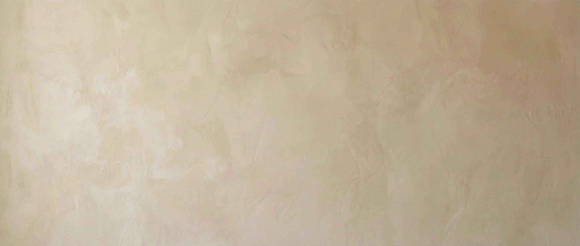 Minimalist warm beige wall texture background, evoking a serene Japandi and slow living atmosphere.