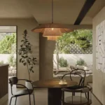 Kyoto rattan pendant light hanging low over a wooden table.