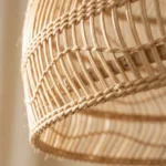 Macro shot of tight handwoven knots on dome rattan shade.