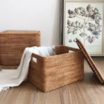 Neat rattan organiser box placed on a shelf for tidy storage.